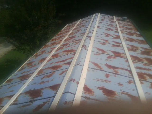 Rusted metal roof panels with new wood purlins before replacement — Storm Damage Roof Repair in Elkin by Roofing Brothers